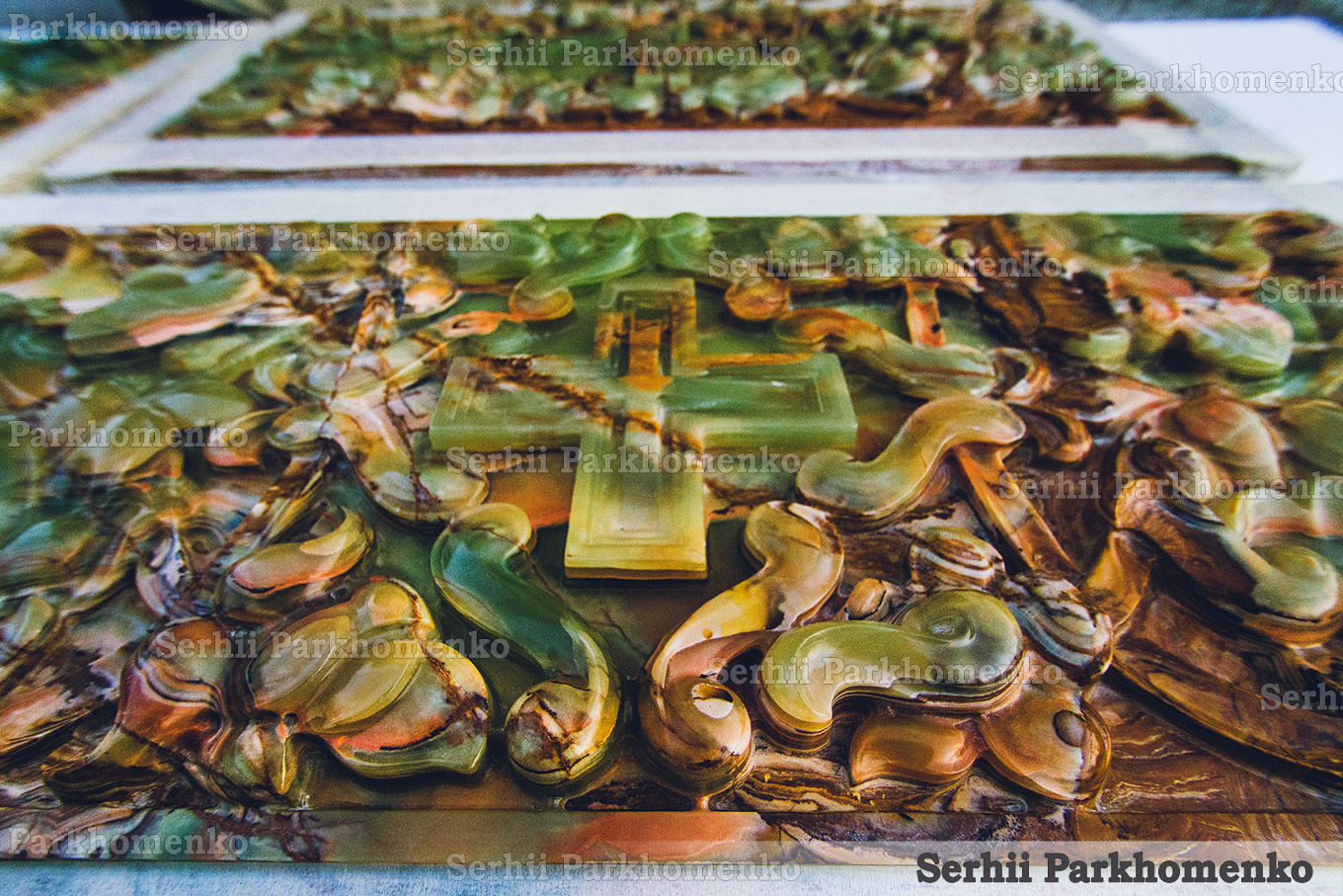 Perspective layout of custom-carved semi-precious green onyx screens in the workshop, showcasing natural layered stone variations