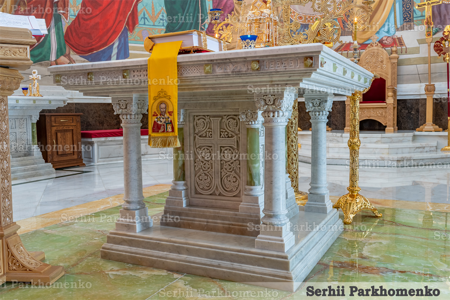 The majestic white marble Altar Table featuring vibrant green onyx pillars inside the Cathedral of the Transfiguration of the Savior by Serhii Parkhomenko's studio