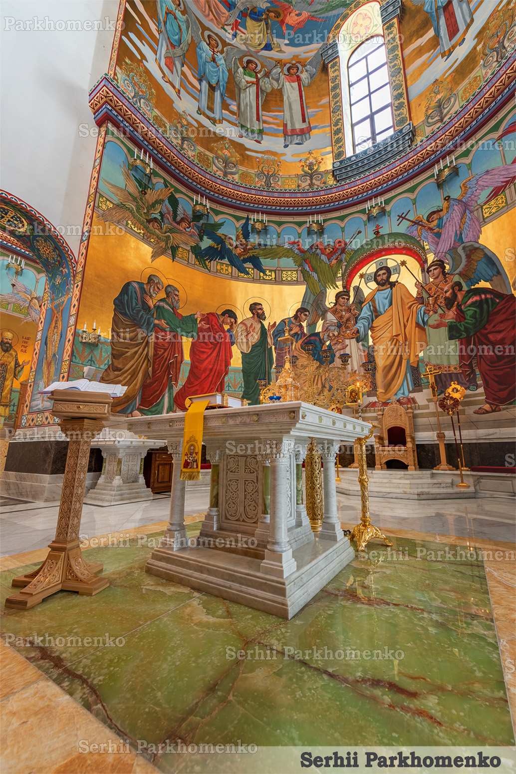 Side view of the carved white marble Altar Table with green onyx columns showing Alpha and Omega symbols at the Cathedral of the Transfiguration of the Savior