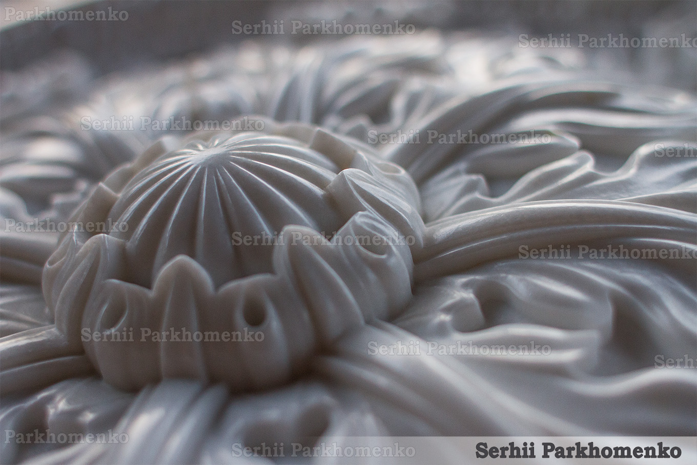 Macro view of a masterfully hand-finished white Thassos marble rosette detailing, capturing fine stone-carving craftsmanship and textures