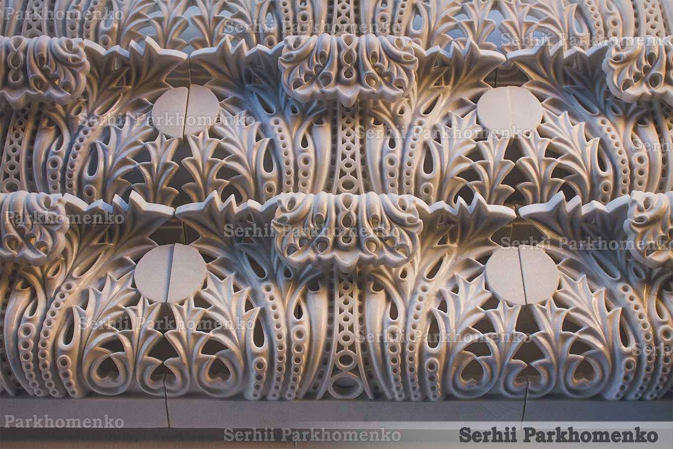 A repetitive layout of finished Neo-Byzantine style openwork stone moldings made of premium white Thassos marble