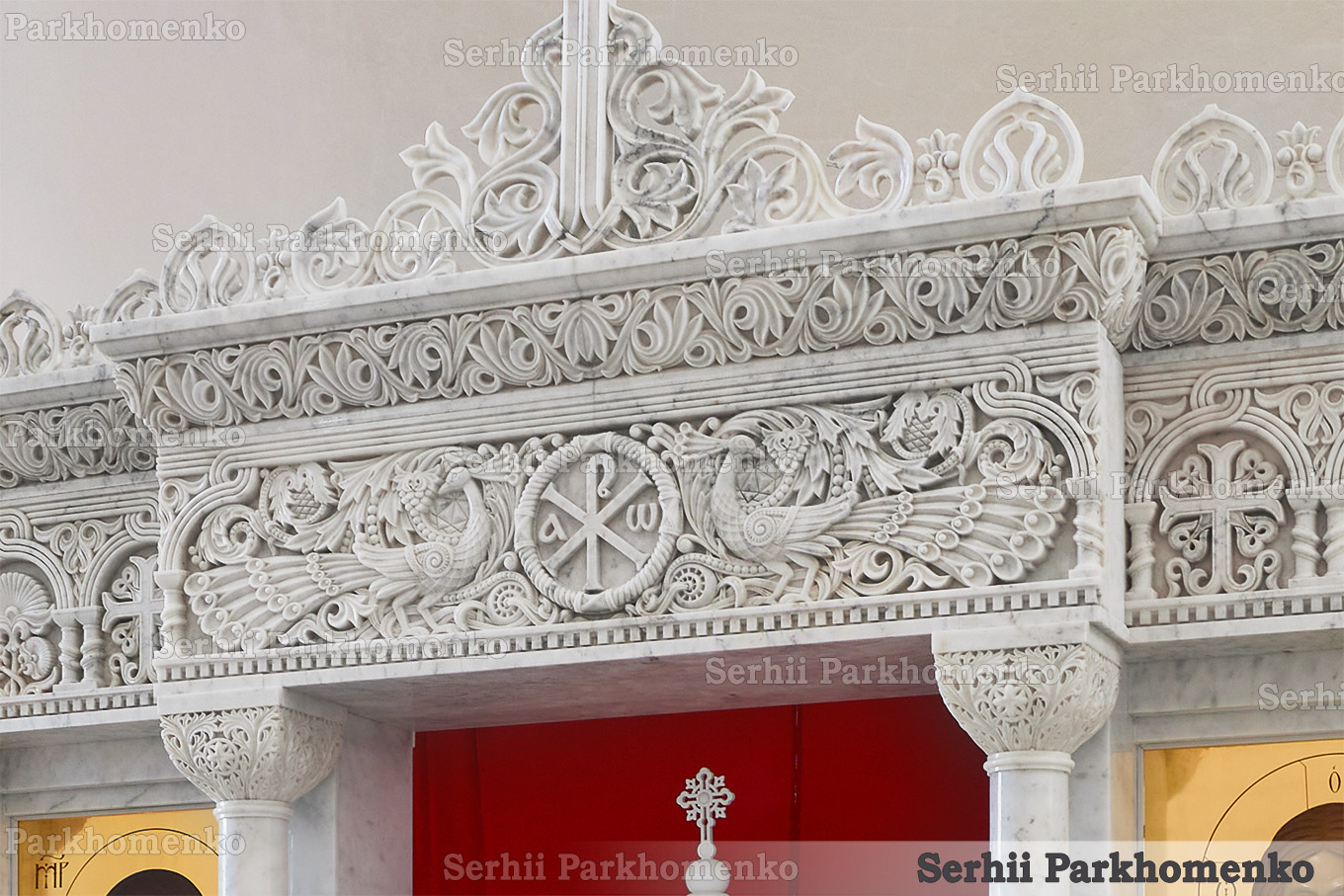 Close-up of Byzantine relief carvings on a Mugla White marble iconostasis featuring the Chi-Rho monogram and peacocks by Serhii Parkhomenko's studio