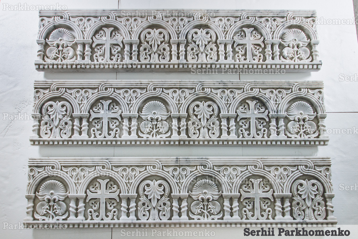 A comprehensive set of three completed white marble iconostasis architrave sections layout in the workshop