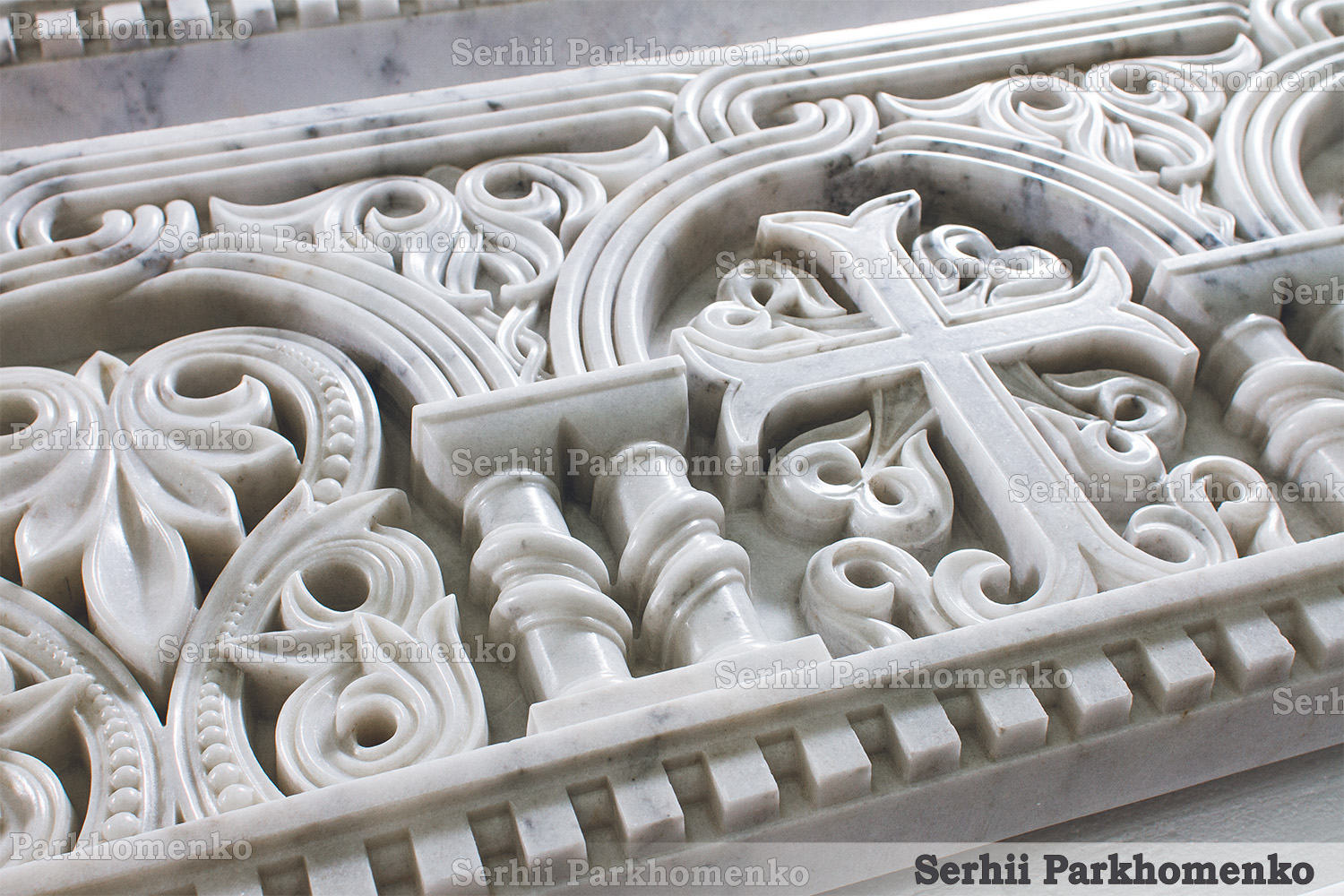 Close-up of the Neo-Byzantine stone relief detailing on a Mugla White marble architrave featuring iconic crosses and palmettes