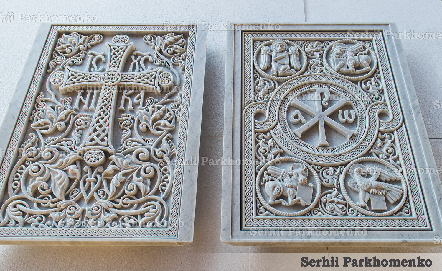 Two custom carved white marble altar panels featuring the Orthodox cross and Chi-Rho with Tetramorph symbols by Serhii Parkhomenko's studio