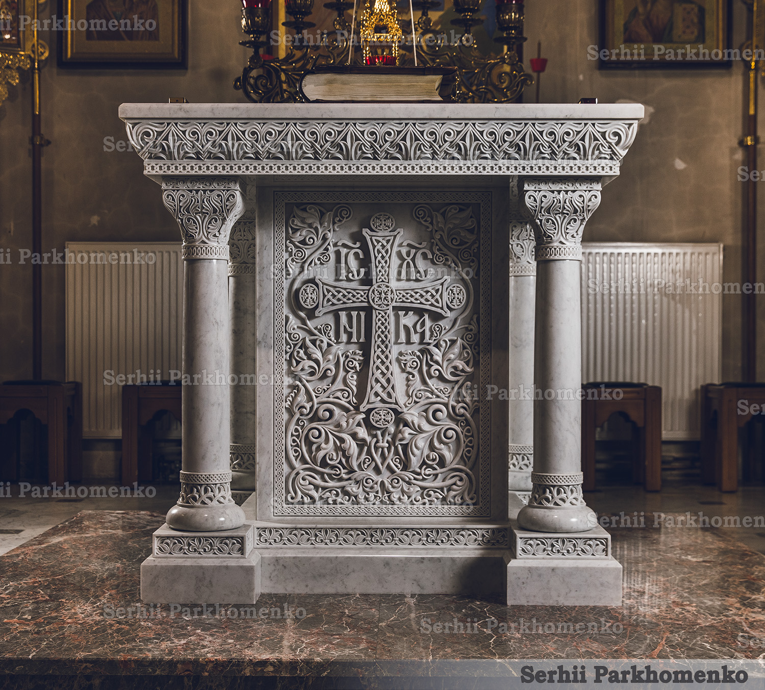 Front view of the masterfully carved white marble Altar Table featuring a prominent central cross with IC XC NI KA monograms at the St. Vladimir Church