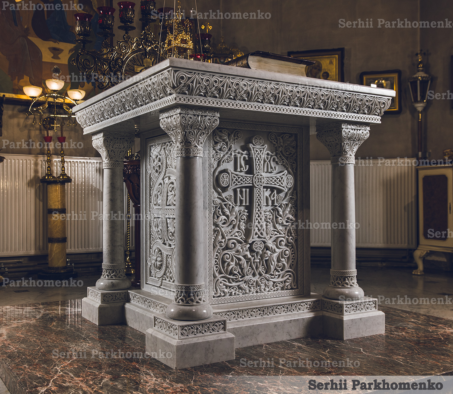 Three-quarter perspective of a bespoke carved marble church Altar Table under warm light, highlighting ornate columns and relief patterns