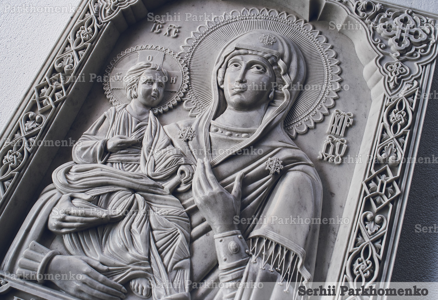Detailed close-up showing the deep bas-relief depth of a hand-finished marble Orthodox icon