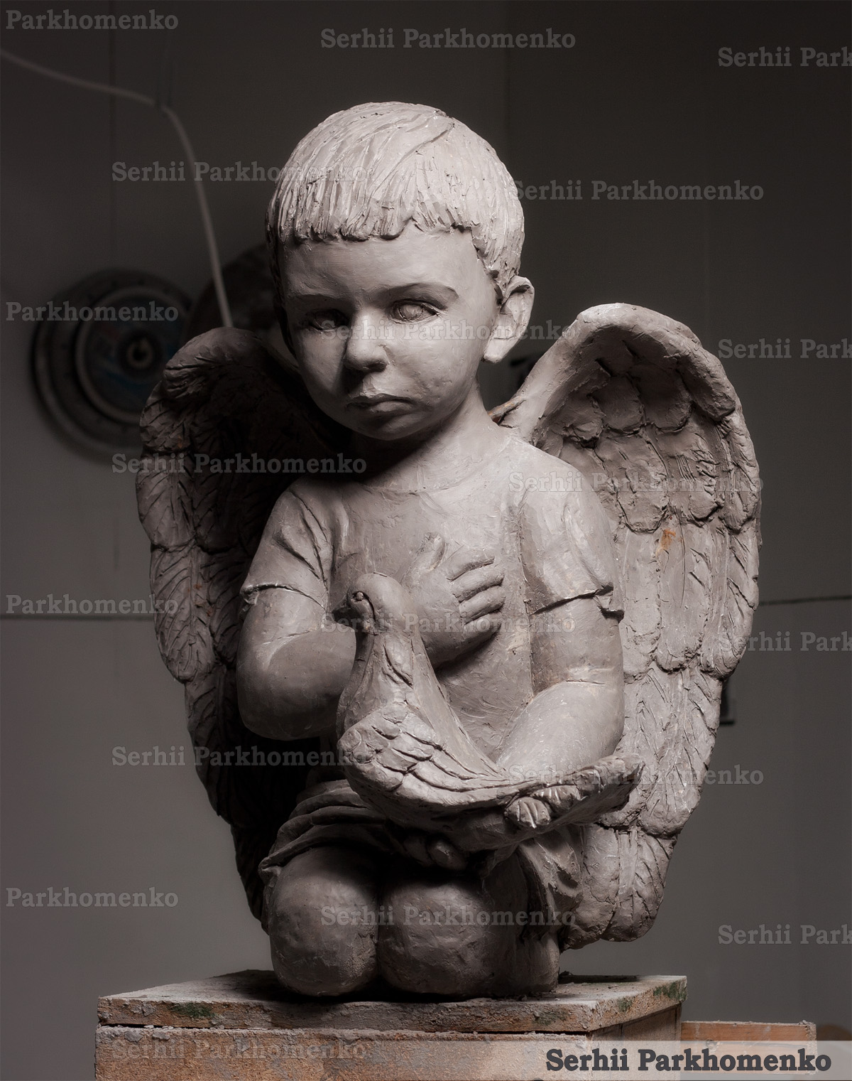 Front view of a custom sculpted clay maquette for a luxury marble angel monument project
