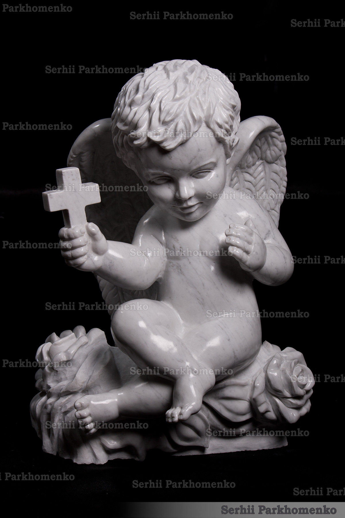 Bespoke hand-carved Bianco Carrara C marble angel sculpture holding a cross by Serhii Parkhomenko's Studio